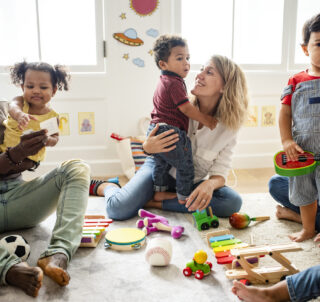 A group of children playing together with adults