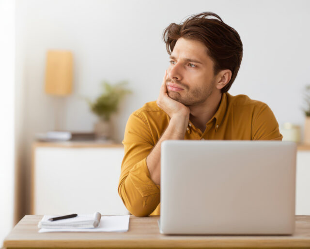 An adult struggling with ADHD at work