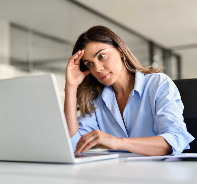 A woman struggling with ADHD at work