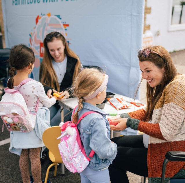 Adults and children engaging in a learning activity during an ADHD assessment appointment.
