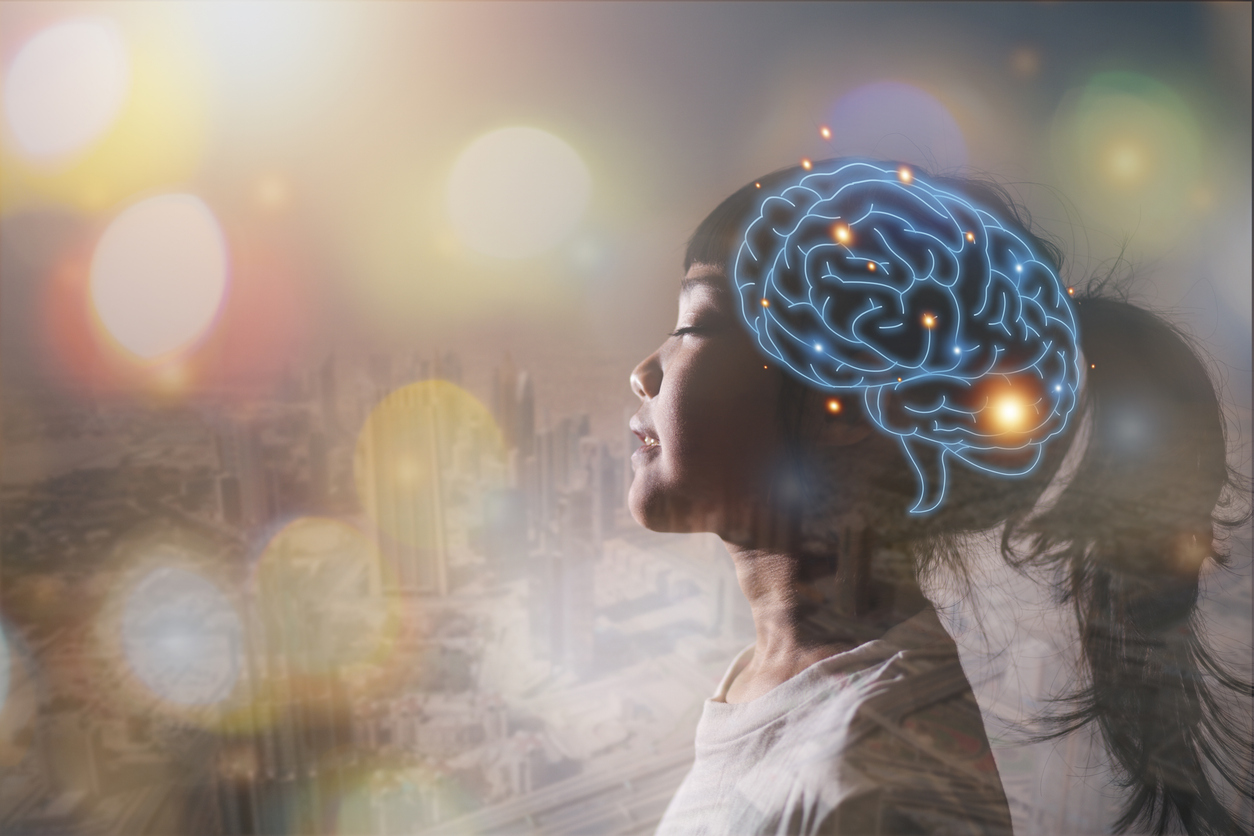 Profile of a girl in side view with a glowing blue brain network overlay and a colorful cityscape backdrop.