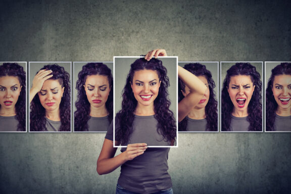 Collage of a woman displaying varied facial expressions, with the center frame emphasized by a white border.